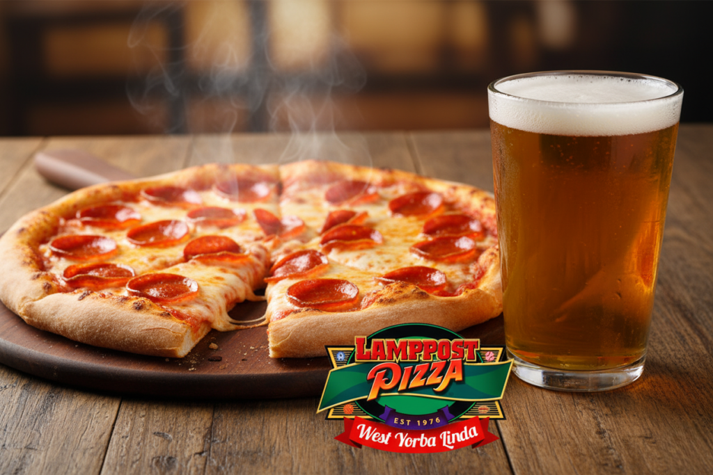 pizza and beer pairing—a golden pint next to a freshly baked pizza on a wooden table.